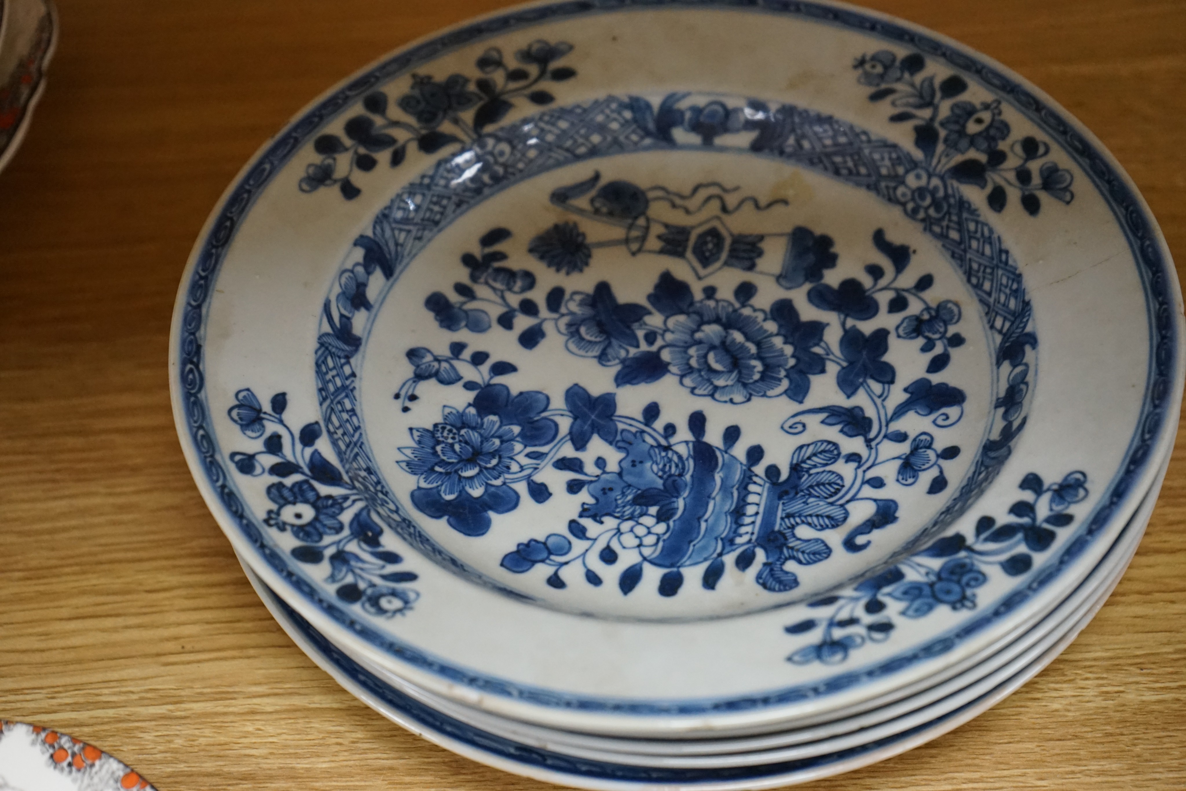 An 18th century Chinese Export blue and white octagonal tureen and cover, decorated with birds and flowers, a pair of similar sauceboats and five plates decorated with urns of flowers